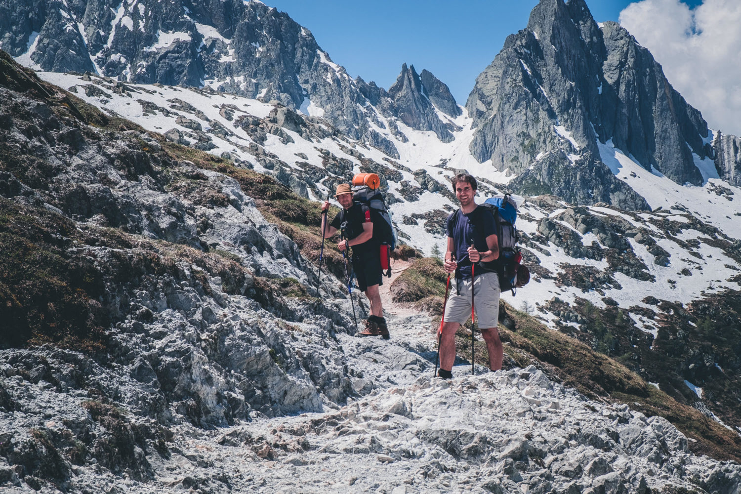 Zwei Wanderer vor hochalpiner Bergkulisse